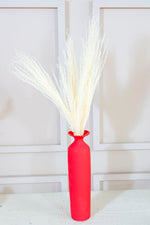 Red long vase with white reed pampas